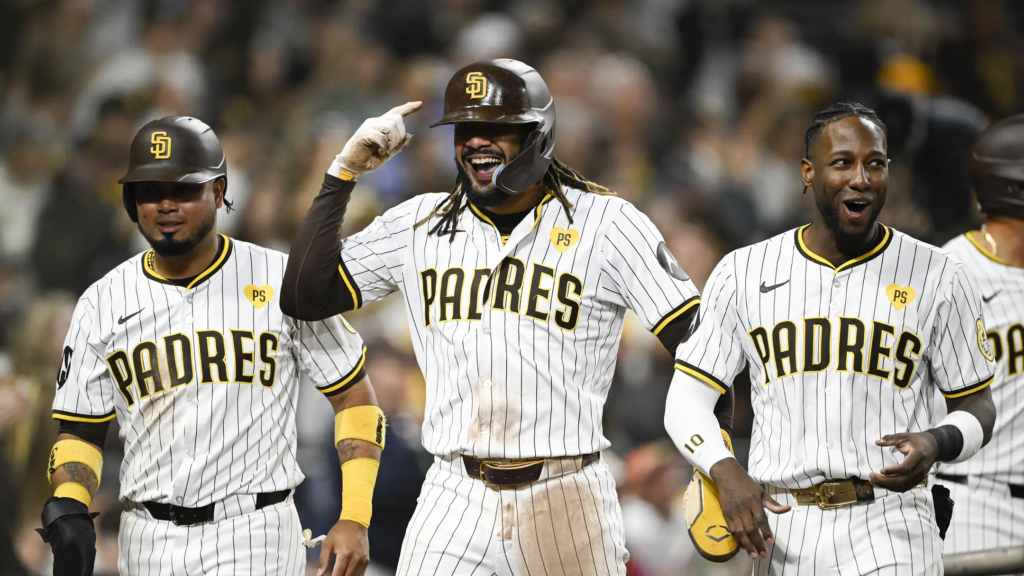 Jun 6, 2024; San Diego, California, USA; San Diego Padres right fielder Fernando Tatis Jr. (23), center, Luis Arraez (4), left, and Jurickson Profar (10) celebrate after Tatis scored during the fifth inning against the Arizona Diamondbacks at Petco Park. Mandatory Credit: Denis Poroy-Imagn Images at Petco Park. | Denis Poroy-Imagn Images