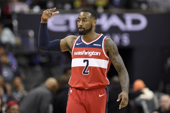 Washington Wizards guard John Wall gestures after hitting a 3-point basket during the second half of the team's NBA basketball game against the Brooklyn Nets, Saturday, Dec. 1, 2018, in Washington. (AP Photo/Nick Wass, File)