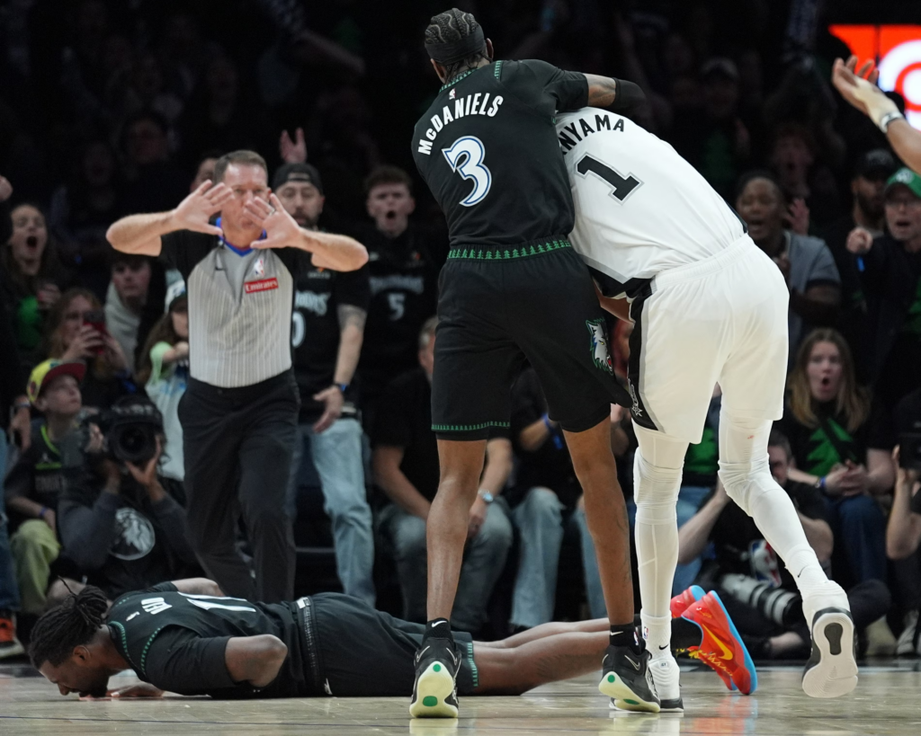 Naz Reid falls to the court after he was fouled by Victor Wembanyama on Sunday. Photograph: Abbie Parr/AP