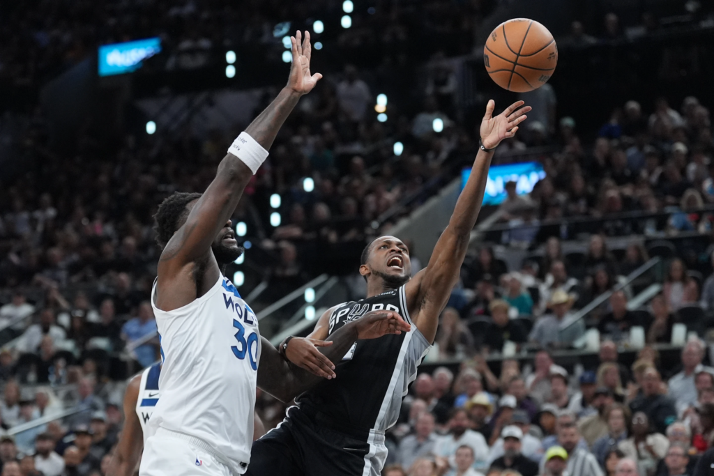 San Antonio Spurs guard De aaron Fox (4) scores past Minnesota Timberwolves forward Julius Randle (30) during the first half of Game 5 of an NBA basketball second-round playoffs series in Minneapolis, Tuesday, May 12, 2026. (AP Photo/Eric Gay)