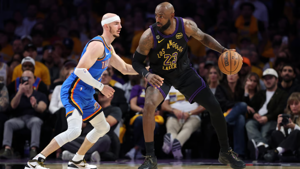 LeBron James #23 of the Los Angeles Lakers dribbles against Alex Caruso #9 of the Oklahoma City Thunder during the fourth quarter in Game Four of the Second Round of the NBA Western Conference Playoffs at Crypto.com Arena on May 11, 2026 in Los Angeles, California. (Photo by Luke Hales/Getty Images)