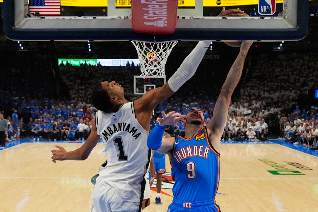 San Antonio Spurs forward Victor Wembanyama (1) blocks a shot by Oklahoma City Thunder guard Alex Caruso (9) during the second half of Game 2 in the Western Conference finals NBA basketball playoffs seriesWednesday, May 20, 2026, in Oklahoma City. (AP Photo/Nate Billings)