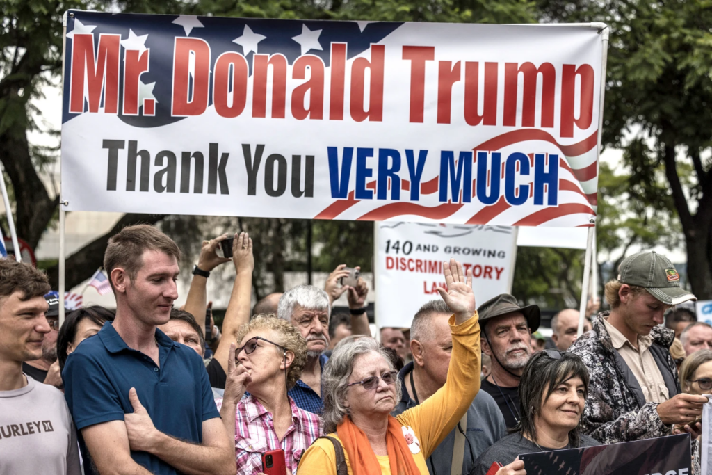 White South Africans supporting President Donald Trump and tech billionaire Elon Musk gather in front of the U.S. Embassy in Pretoria, on Feb. 15, 2025, for a demonstration. File photo by Marco Longari/ AFP via Getty Images