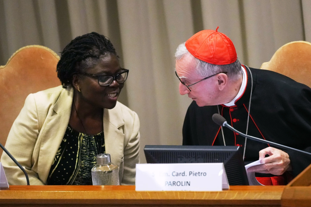 Vatican Secretary of State Cardinal Pietro Parolin, right, talks to theologian Leocadie Lushombo during the presentation of his first encyclical, “Magnifica humanitas: On Safeguarding the Human Person in the Time of Artificial Intelligence,” at the Vatican, Monday, May 25, 2026. (AP Photo/Alessandra Tarantino)