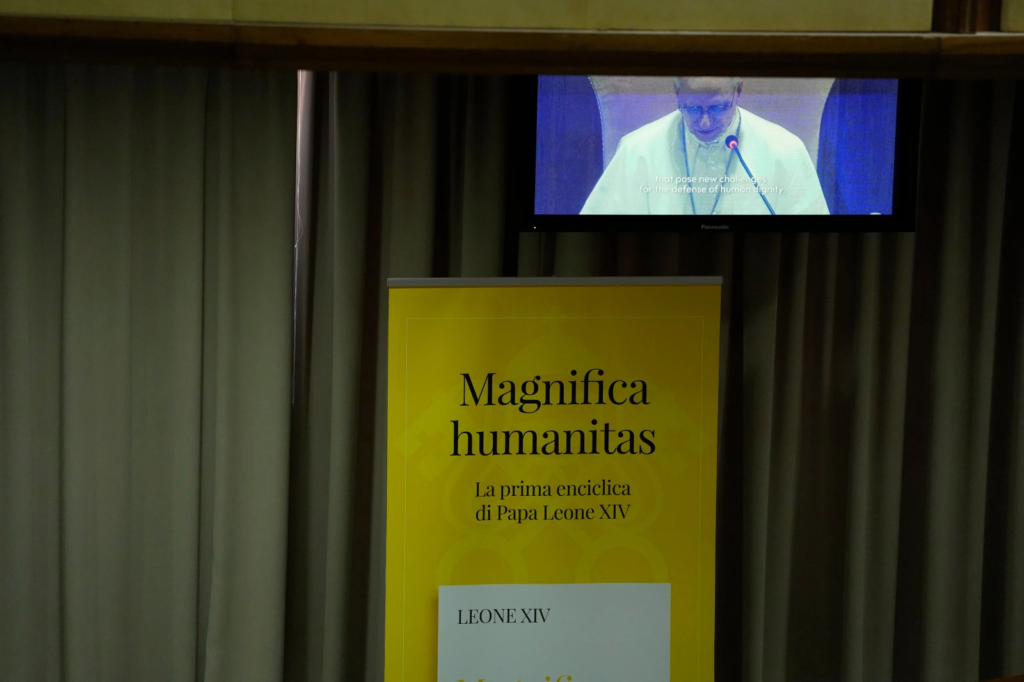 Pope Leo XIV, left, attends the presentation of his first encyclical, “Magnifica humanitas: On Safeguarding the Human Person in the Time of Artificial Intelligence,” at the Vatican, Monday, May 25, 2026. (AP Photo/Alessandra Tarantino)