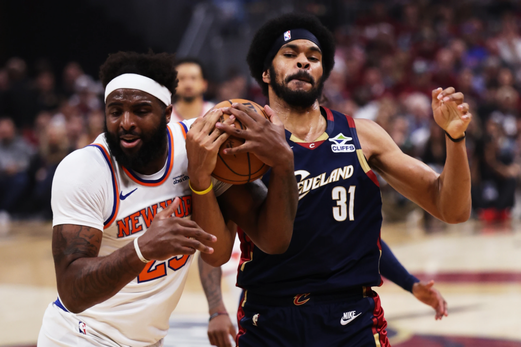 New York Knicks center Mitchell Robinson (23) and Cleveland Cavaliers center Jarrett Allen (31) battle for the ball during the first half of Game 4 in the Eastern Conference finals NBA
basketball playoffs series in Cleveland, Monday, May 25, 2026. (AP Photo/Tim Phillis)