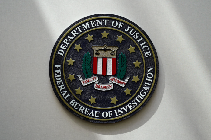 An FBI seal is seen on a wall on Aug. 10, 2022, in Omaha, Neb. Violent crime in the U.S. dropped again in 2023, according to FBI statistics that show a continued trend downward after a coronavirus pandemic-era crime spike. The report released Monday shows overall violent crime ticked down an estimated 3% in 2023 from the year before, according to the FBI. (Photo by Charlie Neibergall, AP, File)