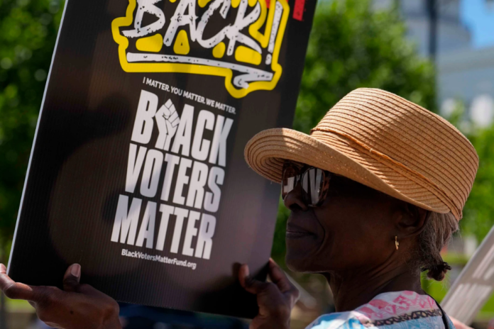 Brenda Cummings, of Montgomery, Ala., protests outside the state house during a special session of the Alabama Legislature, Monday, May 4, 2026, in Montgomery, Ala. (AP Photo/Mike Stewart)
