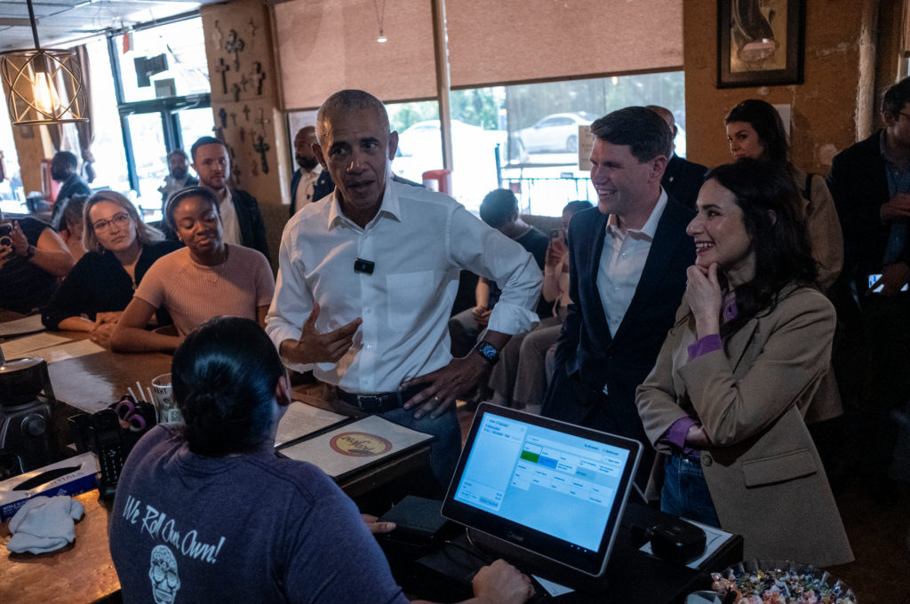 Former President Barack Obama, center left, speaks with workers during a taco stop in Austin, Texas, alongside state Rep. James Talarico, center right, and state Rep. Gina Hinojosa, right.