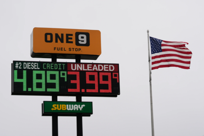 The American Flag flies next to a One9 Fuel Stop sign displaying gas prices for diesel and unleaded gas in Wilmington, Ohio, Wednesday, June 10, 2026. (AP Photo/Carolyn Kaster)