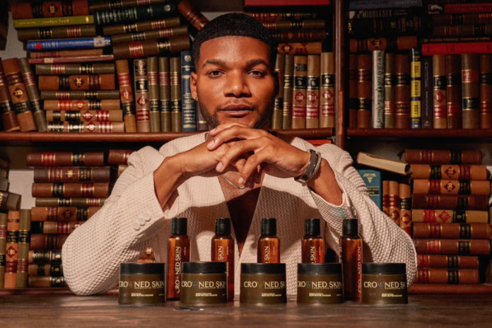 Crowned Skin founder Darrell Spencer with products from his 8-figure brand. Courtesy of: Crowned Skin.