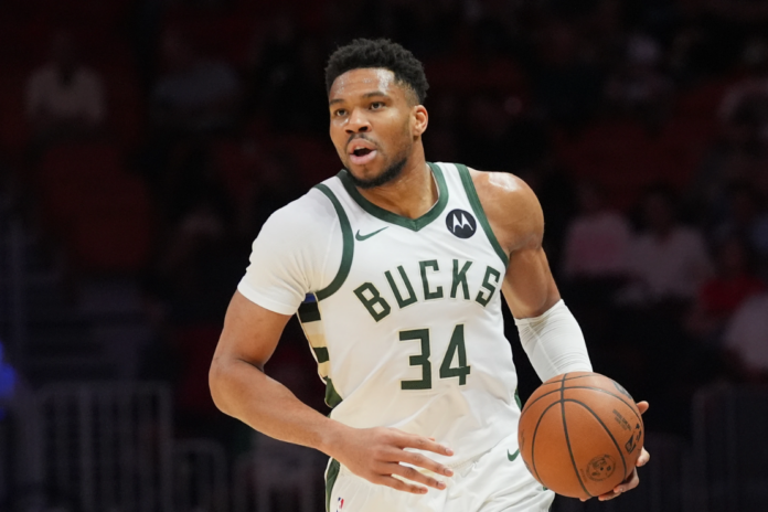 Milwaukee Bucks forward Giannis Antetokounmpo (34) dribbles the ball during the first half of an NBA basketball game against the Miami Heat, March 12, 2026, in Miami. (AP Photo/Marta Lavandier, File)