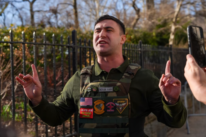 Far-right influencer Jake Lang speaks in front of Gracie Mansion regarding the attempted bombing at a protest organized by the influencer on Saturday, on March 9, 2026 in New York City. Two suspects were arrested on March 7 for allegedly throwing bombs that did not explode during a protest outside Gracie Mansion. (Photo by Ryan Murphy/Getty Images)