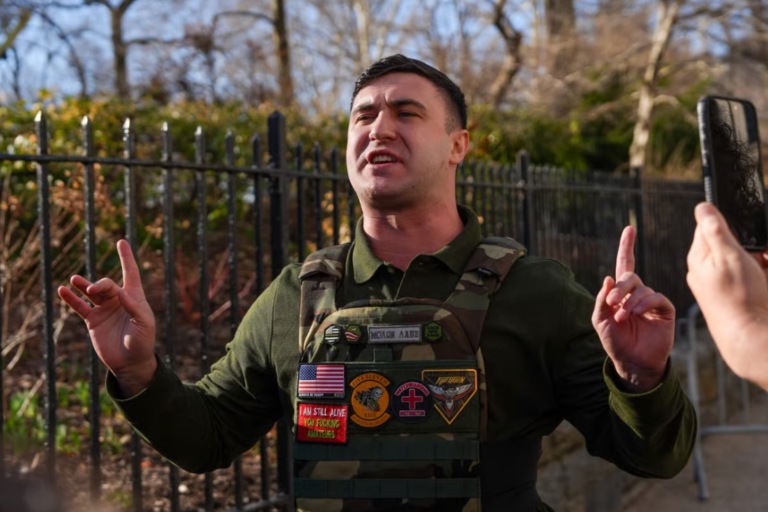 Far-right influencer Jake Lang speaks in front of Gracie Mansion regarding the attempted bombing at a protest organized by the influencer on Saturday, on March 9, 2026 in New York City. Two suspects were arrested on March 7 for allegedly throwing bombs that did not explode during a protest outside Gracie Mansion. (Photo by Ryan Murphy/Getty Images)