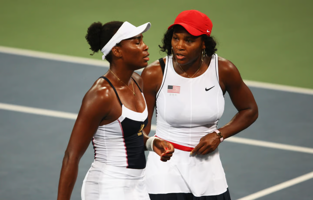 Serena Williams (R) talks to Venus Williams of the United States against Iveta Benesova and Nicole Vaidisova of Czech Republic during the Women’s Doubles First Round match at the Olympic Green Tennis Center during Day 4 of the Beijing 2008 Olympic Games on August 12, 2008 in Beijing, China. (Photo by Clive Brunskill/Getty Images)