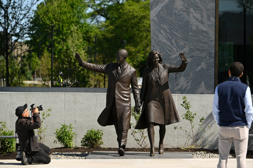 Statues of former President Barack Obama and former First Lady Michelle Obama at the Obama Presidential Center in Chicago, Thursday, May 28, 2026. (AP Photo/Paul Beaty) Visitors photograph statues of former President Barack Obama and former First Lady Michelle Obama at the Obama Presidential Center in Chicago, Thursday, May 28, 2026. (AP Photo/Paul Beaty) 3 of 6 | Visitors photograph statues of former President Barack Obama and former First Lady Michelle Obama at the Obama Presidential Center in Chicago, Thursday, May 28, 2026. (AP Photo/Paul Beaty) The President's reading room at the Chicago Public Library at the Obama Presidential Center in Chicago, Thursday, May 28, 2026. (AP Photo/Paul Beaty) 4 of 6 | The President’s reading room at the Chicago Public Library at the Obama Presidential Center in Chicago, Thursday, May 28, 2026. (AP Photo/Paul Beaty) Visitors tour a replica of former President Barack Obama's oval office at the Obama Presidential Center in Chicago, Thursday, May 28, 2026. (AP Photo/Paul Beaty) 5 of 6 | Visitors tour a replica of former President Barack Obama’s oval office at the Obama Presidential Center in Chicago, Thursday, May 28, 2026. (AP Photo/Paul Beaty) Former First Lady Michelle Obama's dresses on display at the Obama Presidential Center in Chicago, Thursday, May 28, 2026. (AP Photo/Paul Beaty) 6 of 6 | Former First Lady Michelle Obama’s dresses on display at the Obama Presidential Center in Chicago, Thursday, May 28, 2026. (AP Photo/Paul Beaty)