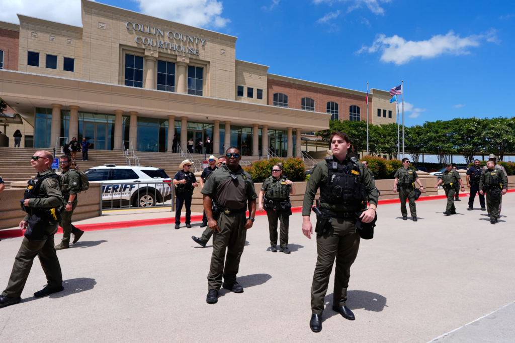 Law enforcement officials stand in front of the Collin County courthouse after the verdict was reached in the Karmelo Anthony trial Tuesday, June 9, 2026, in McKinney, Texas. (AP Photo/Tony Gutierrez)