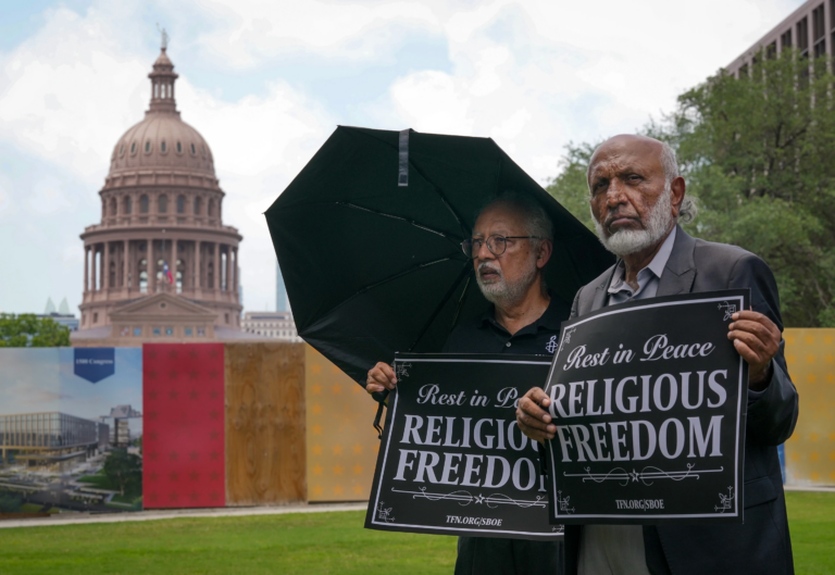 Mohammed Nasrullah, left, and Aziz Soomro, both of Houston, participate in an interfaith funeral-themed protest outside the Barbara Jordan Building in Austin on Monday, June 22, 2026. (Jay Janner/Austin American-Statesman via AP)