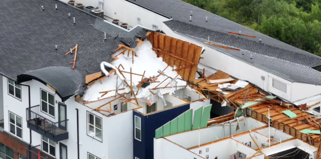 Aerial footage shows extensive tornado damage at the Oasis San Antonio apartments, where sections of the roof and upper floors were torn away near Interstate 10.