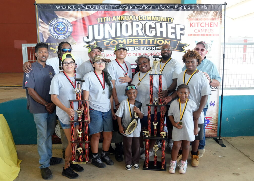 The Martinez and Loving families competed in the 11th Annual Community Junior Chef Competition at Mission County Park on July 18, 2026. Team Loving won the competition, with Team Martinez placing second after both families prepared Watusi and Chinese black deer overnight. (Photo by Burrell Parmer)
