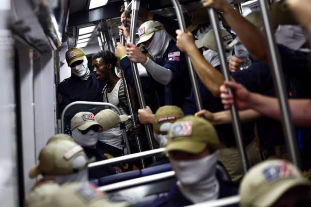 A passenger looks on as apparent members of the white supremacist group Patriot Front ride the Washington Metro on July 4, 2026 in Washington, D.C. Numerous events, activities, and fireworks are planned in celebration of America's 250th Anniversary. (Photo by Finn Gomez/Getty Images)
