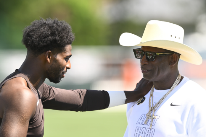 NFL Hall of Fame member Deion Sanders, left, talks with his son Cleveland Browns quarterback Shedeur Sanders, after practice at the team's NFL football training camp, Thursday, July 30, 2026, in Berea, Ohio. (AP Photo/David Richard)