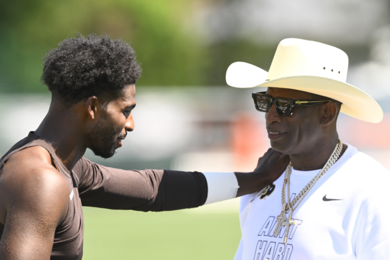 NFL Hall of Fame member Deion Sanders, left, talks with his son Cleveland Browns quarterback Shedeur Sanders, after practice at the team's NFL football training camp, Thursday, July 30, 2026, in Berea, Ohio. (AP Photo/David Richard)