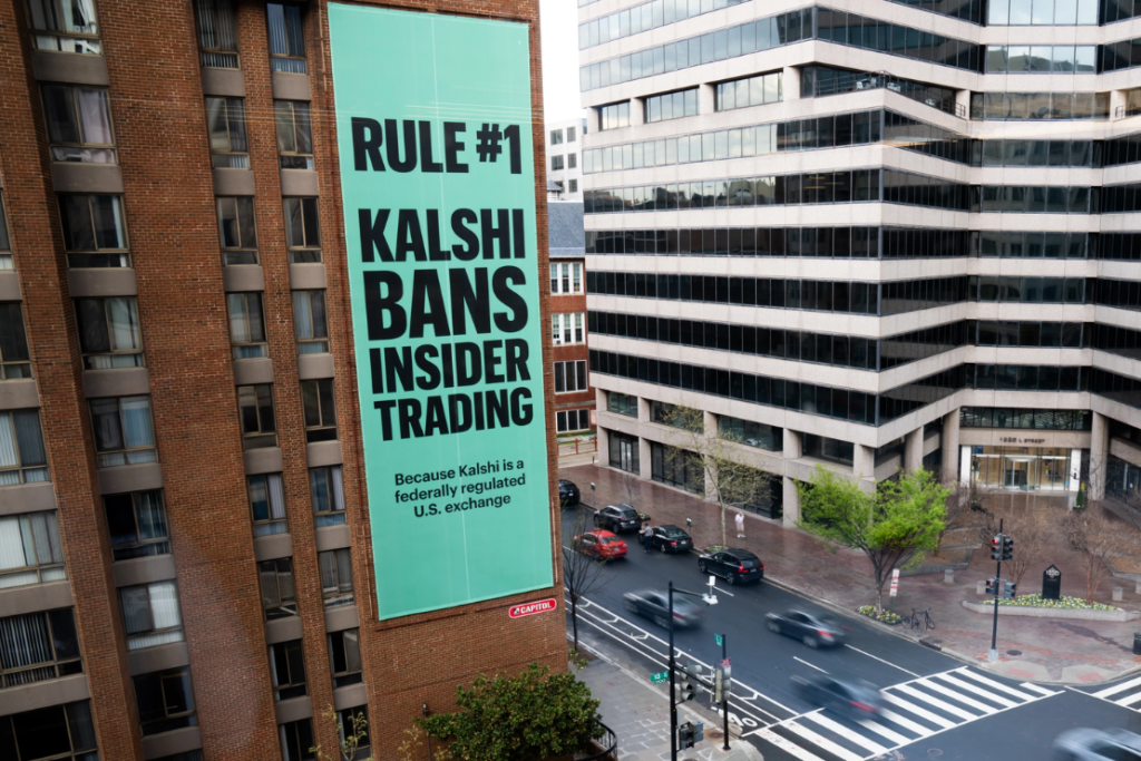 An advertisement for prediction market platform Kalshi hangs at 13th and L Streets in northwest Washington, April 1, 2026. (AP Photo/Allison Robbert, File)