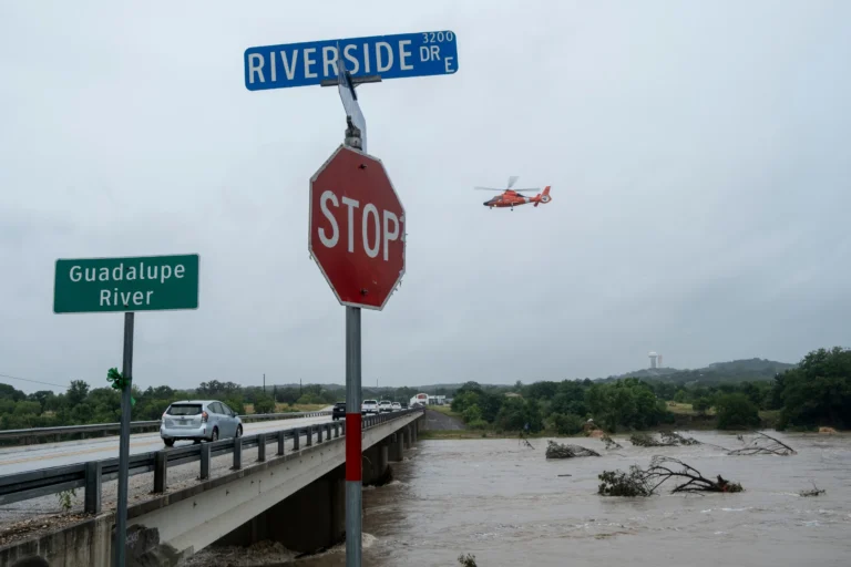 A helicopter flies over the Guadalupe River as floods pass through the area on Thursday, July 16, 2026, in Kerrville, Texas. (AP Photo/Joel Angel Juarez)