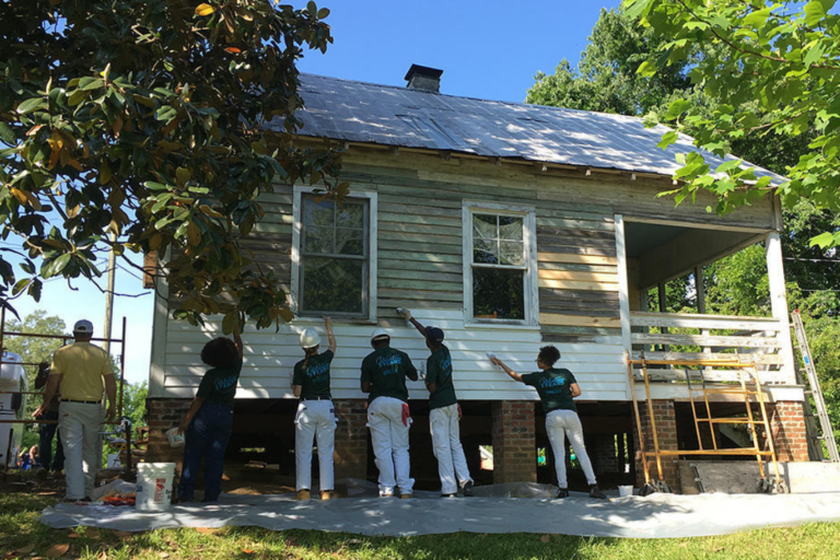 Participants paint the exterior of Nina Simone's childhood home in Tryon, North Carolina.