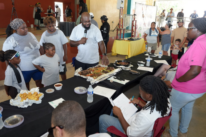 Corey Loving presents Team Loving’s entrées to judges during the 11th Annual Community Junior Chef Competition at Mission County Park on July 18, 2026. (Photo by Burrell Parmer)