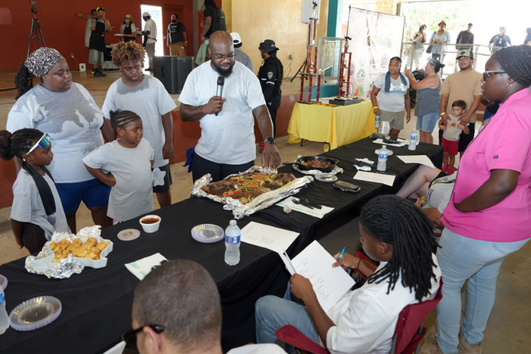 Corey Loving presents Team Loving’s entrées to judges during the 11th Annual Community Junior Chef Competition at Mission County Park on July 18, 2026. (Photo by Burrell Parmer)