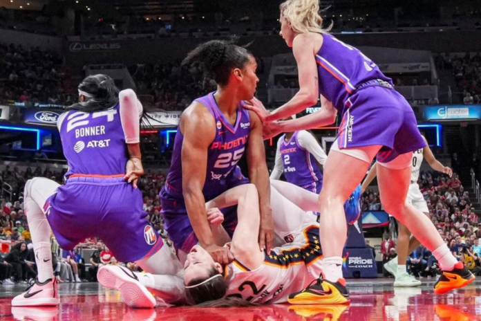 Phoenix Mercury forward Alyssa Thomas scrambles to get up over Indiana Fever guard Caitlin Clark on June 24 during a game in Indianapolis. Grace Smith, IndyStar