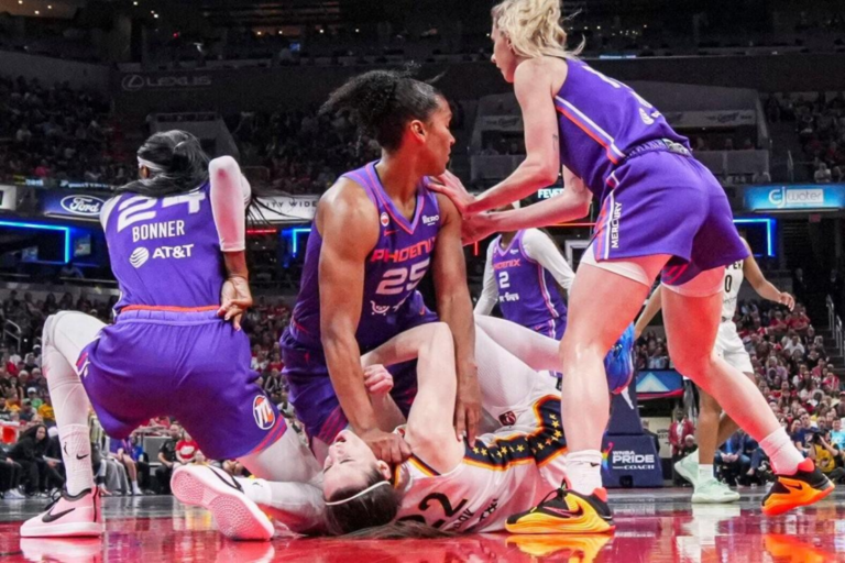 Phoenix Mercury forward Alyssa Thomas scrambles to get up over Indiana Fever guard Caitlin Clark on June 24 during a game in Indianapolis. Grace Smith, IndyStar