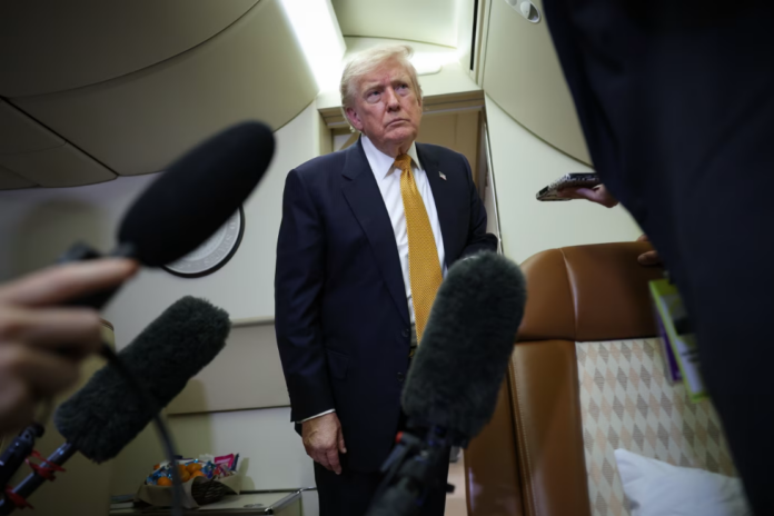 President Trump speaks to members of the press aboard the new Air Force One. Win McNamee/Getty Images