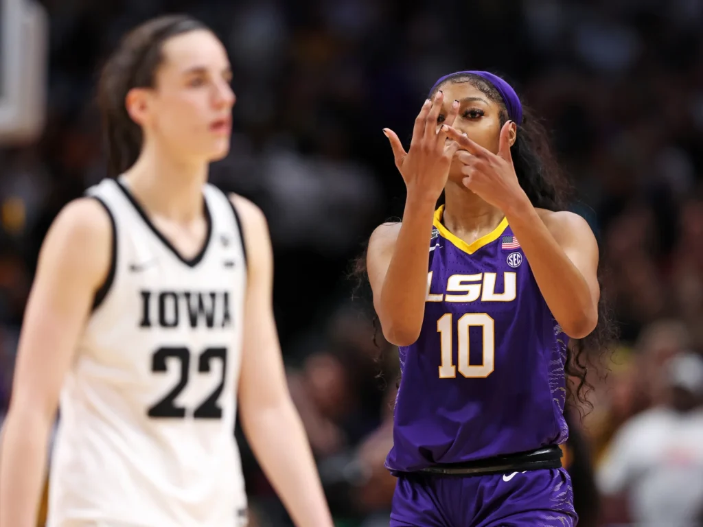 Angel Reese of the LSU Tigers gestures toward Caitlin Clark of the Iowa Hawkeyes toward the end of the NCAA Women's Basketball Tournament championship game in Dallas on Sunday. Maddie Meyer/Getty Images