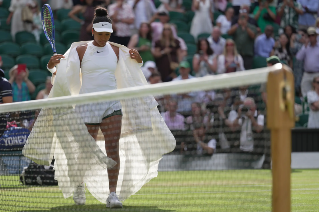 Naomi Osaka of Japan enters the centre court to play against Aryna Sabalenka of Belarus in their fourth round women's singles match at the Wimbledon Tennis Championships in London, Sunday, July 5, 2026. (AP Photo/Brian Inganga)
