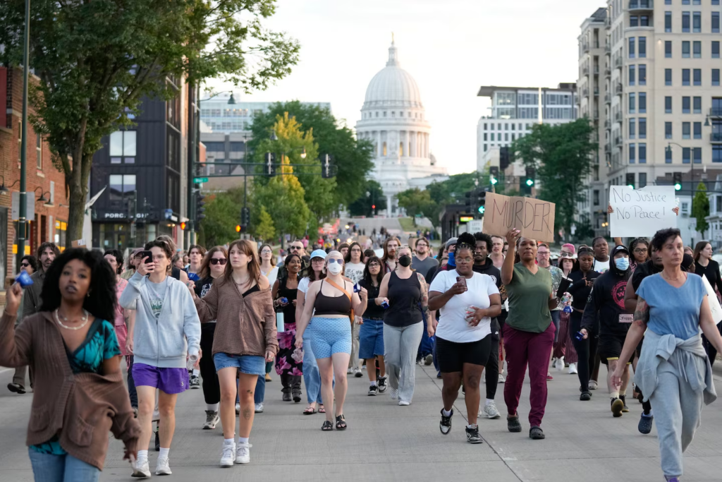 People march on Wednesday to protest a Madison police officer's fatal shooting of a man who authorities said was armed with a knife. (Kayla Wolf/AP)