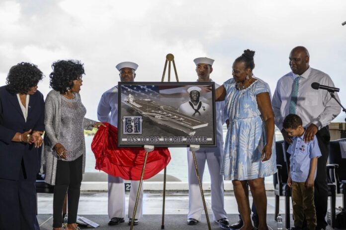 Family members of World War II hero Doris “Dorie” Miller react after the unveiling of the new Ford-class aircraft carrier USS Doris Miller (CVN 81) at an event on Joint Base Pearl Harbor-Hickam in 2020. (U.S. Navy photo by Mass Communication Specialist 2nd Class Alexander C. Kubitza/Released)