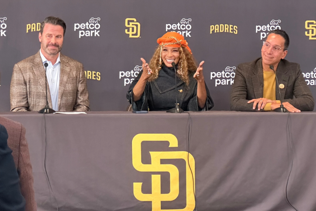 New San Diego Padres owners Kwanza Jones, center, and José E. Feliciano, right, speak at a news conference with team CEO Erik Greupner, left, at Petco Park in San Diego, Calif., Monday, Aug. 24, 2026. (AP Photo/Greg Beacham)