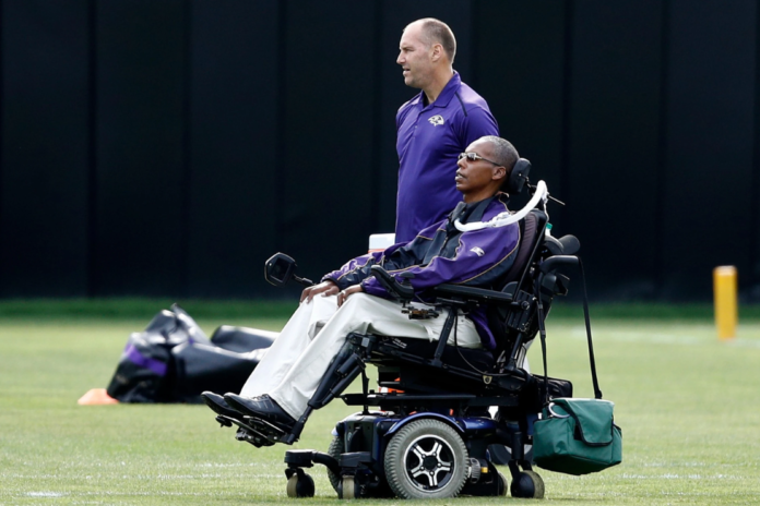 Baltimore Ravens senior advisor to player engagement O.J. Brigance, bottom, watches an NFL football training camp practice in Owings Mills, Md., Aug. 8, 2017. (AP Photo/Patrick Semansky, File)