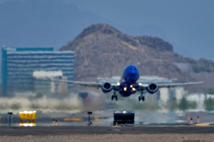 A jet takes flight as heat ripples radiate from the runway at Sky Harbor International Airport in Phoenix, on July 25, 2023. (AP Photo/Matt York, File)